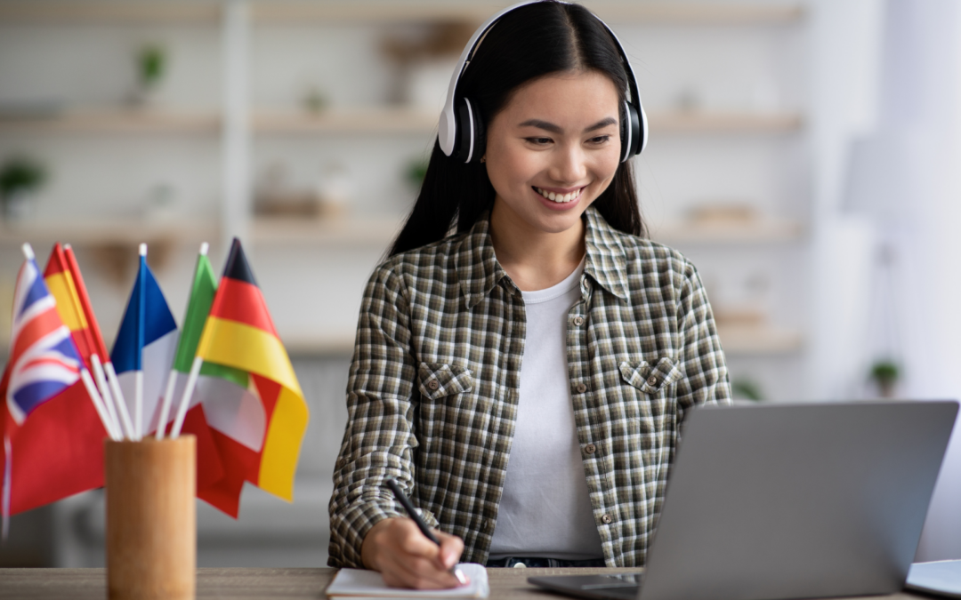 Woman on her computer with tons of different country flags next to her