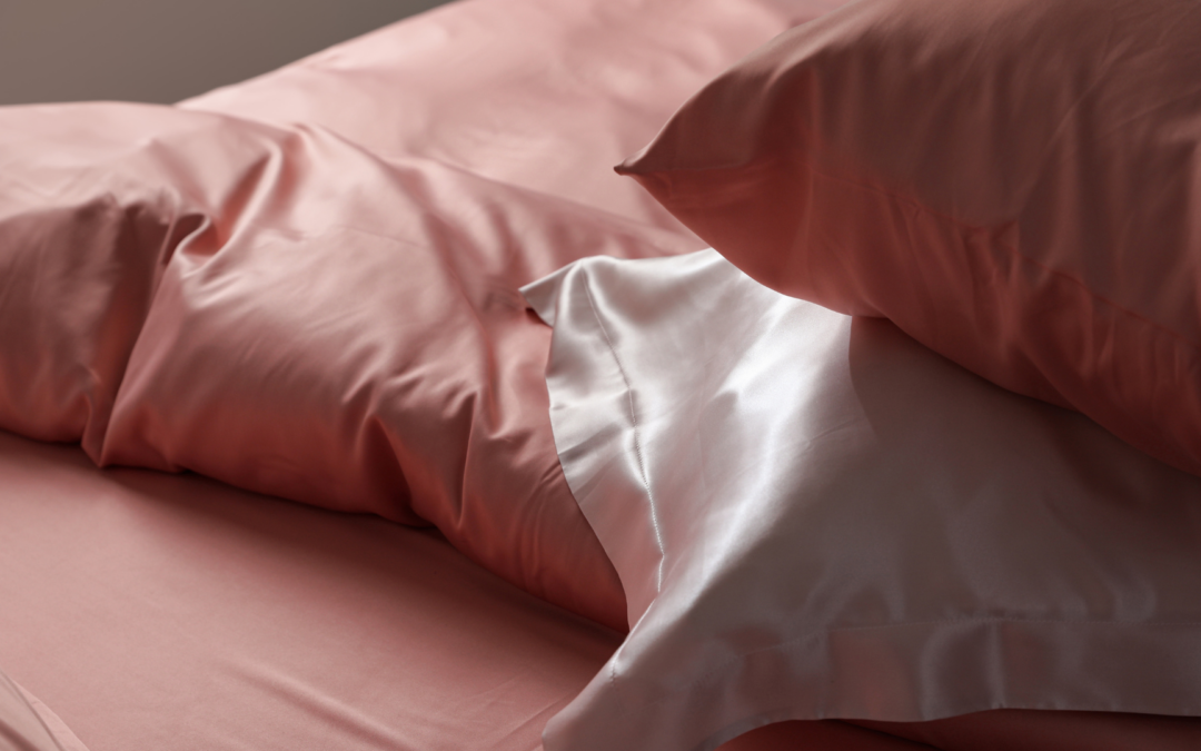 pink silk pillowcase on a bed