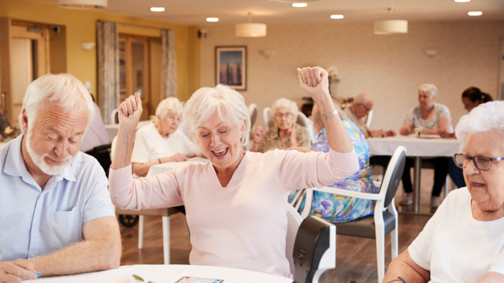Group of elderly people playing bingo and looking happy