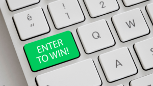 Keyboard with green key that says "enter to win"