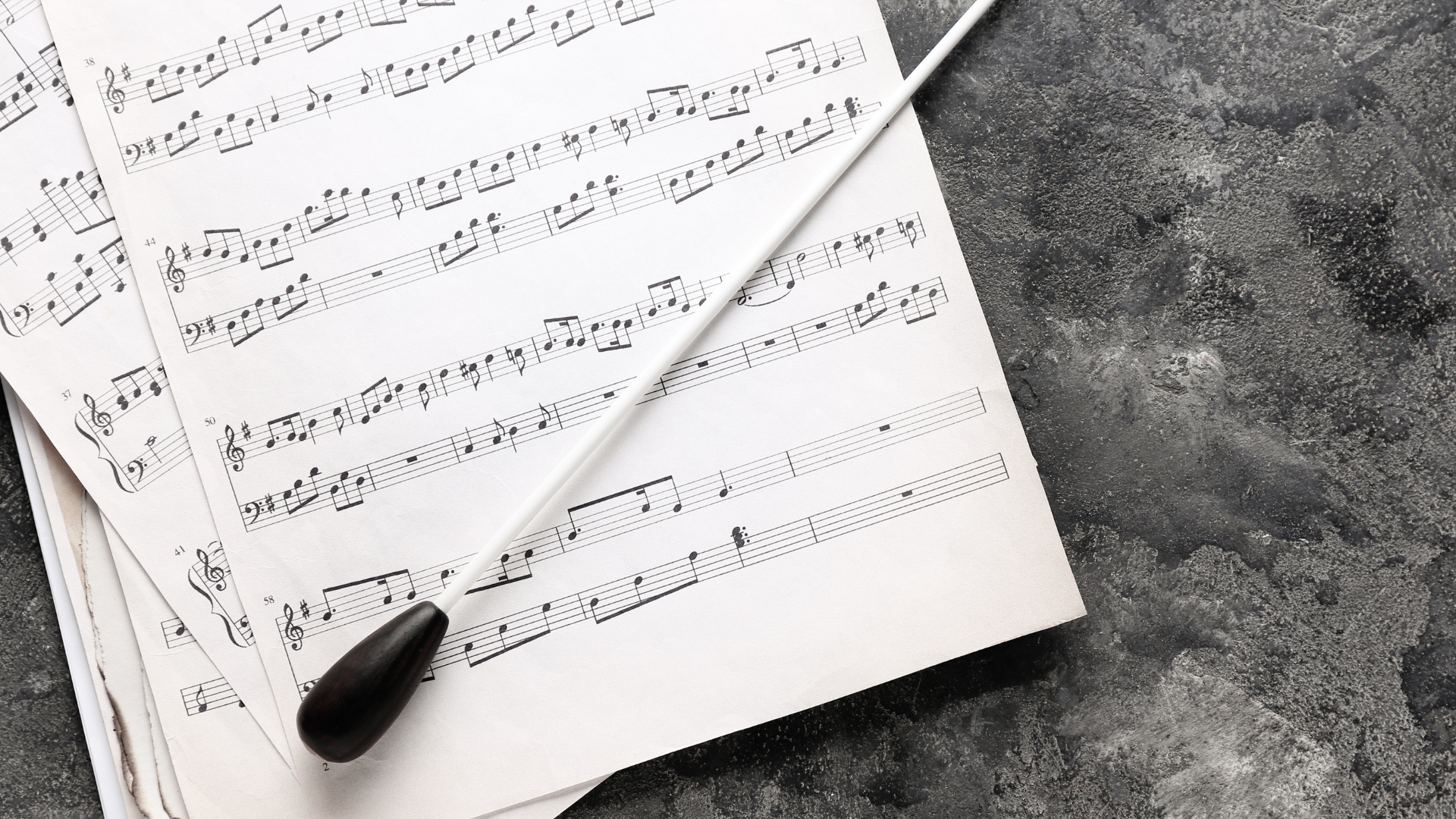 Music score with a conductors baton